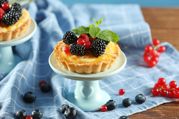 Tasty tartlet with berries on table