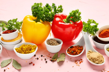 Composition with different spices on color background