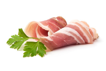 Twisted pieces of pork farmer meat or bacon with parsley, isolated on white background.