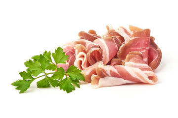 Twisted pieces of pork farmer meat or bacon with parsley, isolated on white background.