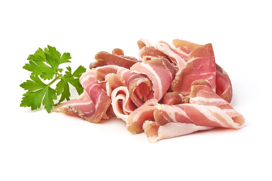 Twisted pieces of pork farmer meat or bacon with parsley, isolated on white background.