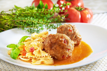 American cuisine. Pasta with meatballs and basil with sauce.