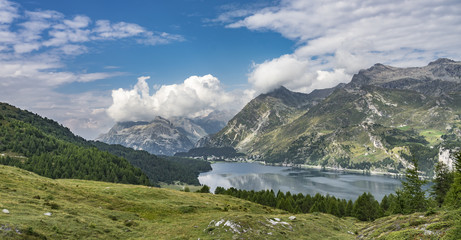 Fototapeta na wymiar aerial view over the upper Engadine, Graubuenden, Switzerland, with lake and village of Maloja