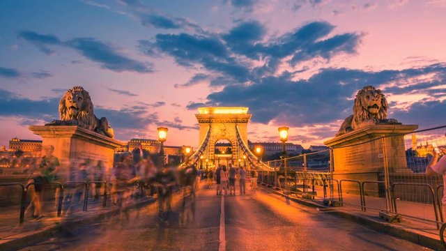 Szechenyi Chain Bridge in Budapest with a blurred crowd of people at sunset. Time lapse.