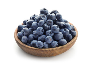 Bowl with ripe blueberries on white background