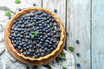 Delicious blueberry pie on wooden table