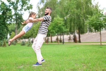 Little girl and her father playing outdoors