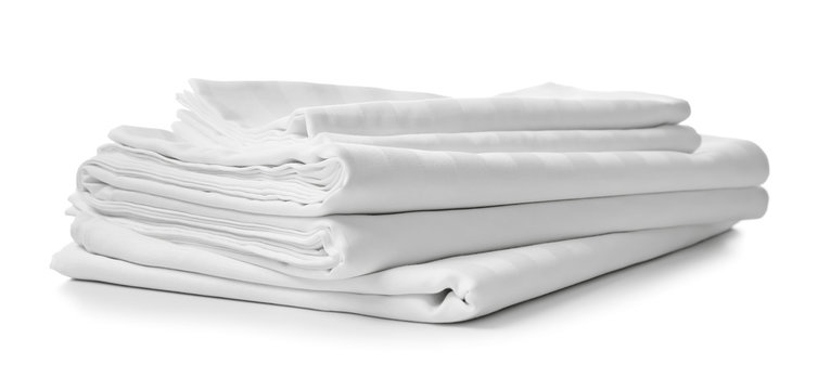 Stack of clean bed sheets on white background