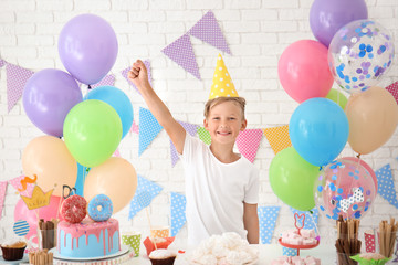 Obraz na płótnie Canvas Cute little boy celebrating Birthday at home