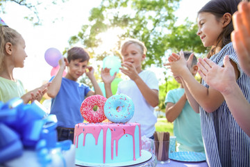 Cute little children celebrating Birthday outdoors