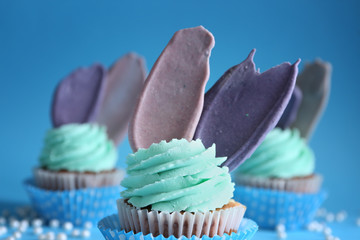 Delicious birthday cupcake on color background, closeup