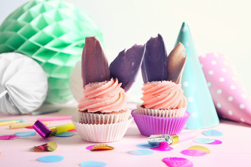 Delicious birthday cupcakes on table