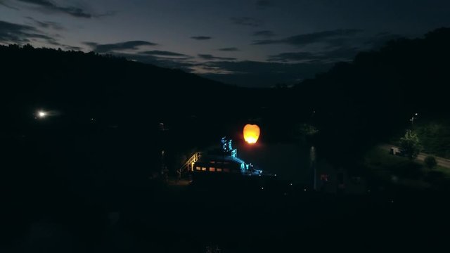 Aerial shot: Night action. A scene of recognition in love, a request of the hand and heart on the ship