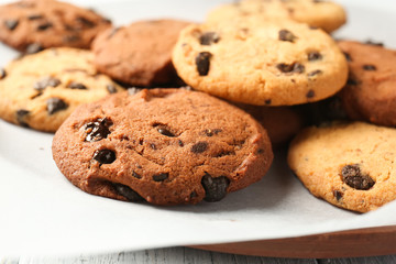 Plate with tasty chocolate cookies on table, closeup