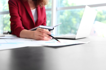 Successful businesswoman working in office, closeup