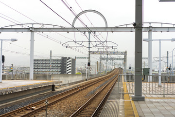 Fototapeta premium Osaka, Japan - APRIL 15, 2018. Passengers waiting at a JR Railway Station. The railway system in Japan has a high reputation for punctuality and safety.