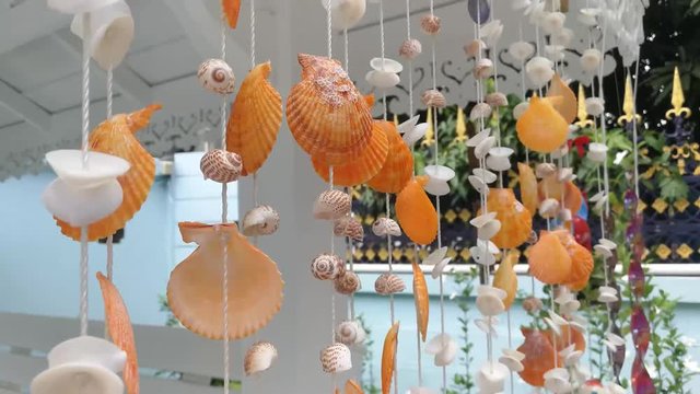 Hanging seashells chime together with every gentle breeze