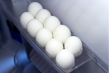 White chiken eggs in the fridge