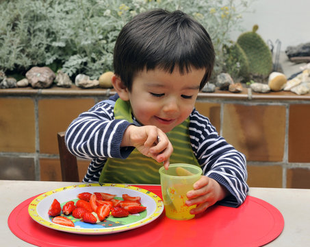 Two-year-old boy having lunch