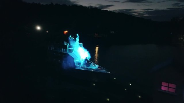 Aerial shot: Night action. A scene of recognition in love, a request of the hand and heart on the ship