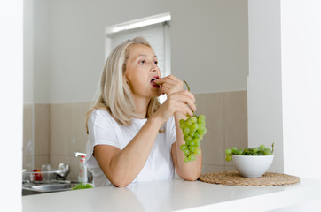 Woman eating grapes