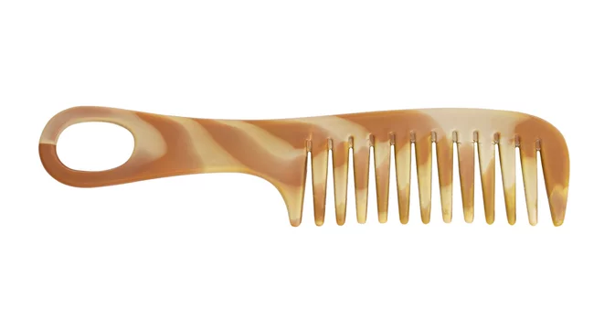 Fotka „Brown comb made by plastic, wood or metal with a row of narrow  teeth, used for arranging the hair.“ ze služby Stock | Adobe Stock