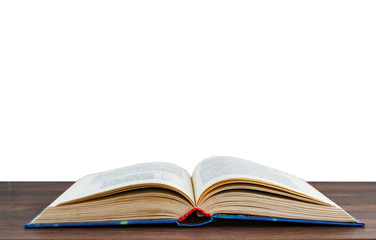 unfolded book on a wooden surface isolated