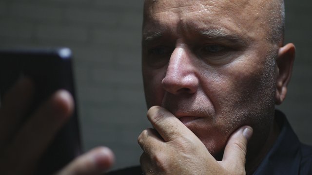 Warried Businessperson Text Using Cellphone Communication