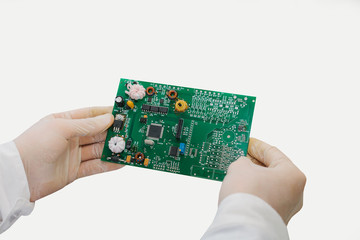 A man is holding a computer board isolated on a white background.