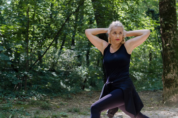 Mature woman stretching in park