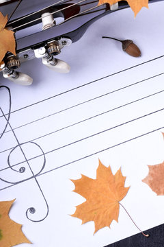 Music autumn composition consisting of guitar, cones, dry leaves and musical staff