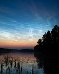 Obraz premium Night shining clouds over lake in Finland
