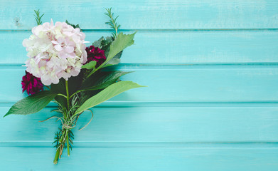 Hydrangea and dahlia on blue background. Space to write.