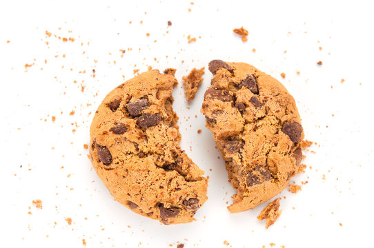 Broken chocolate cookie with crumbs on white background