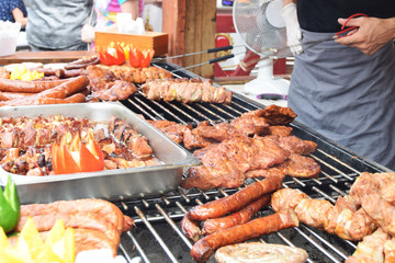 sausage steaks skewers grilled at festivity with peppers