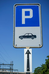 blue car parking sign with illustration and white arrow