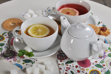various cookies and biscuits baked at home in a container and tea in a retro cup with free space for text