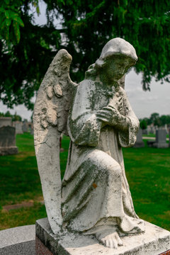 Angel Statue on top of a Gravestone