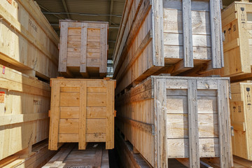 Wooden pallets for shipping stacked in industrial warehouse