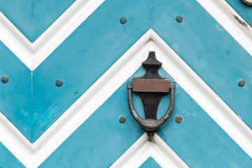 Old blue/ white wooden door with door knocker