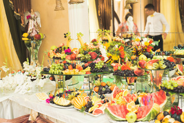 Delicious and tasty dessert table with cupcakes shots at reception closeup