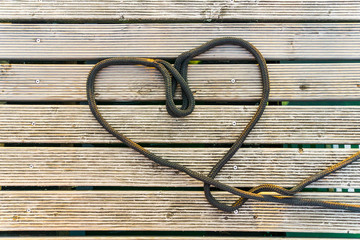 Heart symbol of love, formed of black rope