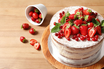 Delicious homemade cake with fresh berries on wooden table