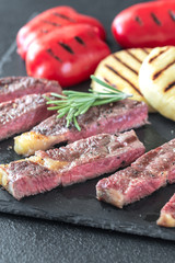 Grilled beef steak with bell peppers and cheese