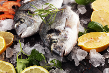 Delicious fresh fish. Fish with aromatic herbs, spices and vegetables - healthy food, diet or cooking concept.