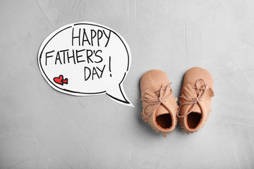 Flat lay composition with baby shoes on gray background. Happy Father's Day