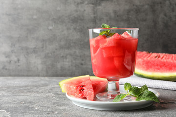 Tasty summer watermelon drink served on table against gray background. Space for text