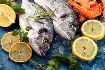 Delicious fresh fish. Fish with aromatic herbs, spices and vegetables - healthy food, diet or cooking concept.