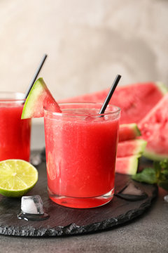 Tasty summer watermelon drink in glass served on table