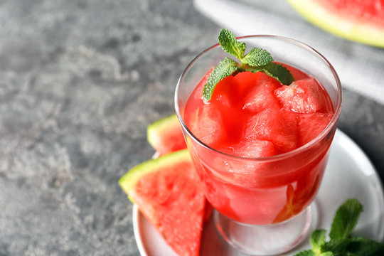 Tasty summer watermelon drink with mint on table, closeup